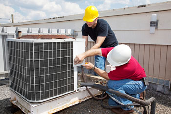 Two men providing heating and air conditioning repair in Gonzales, LA